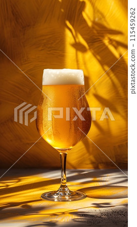 Closeup of a Beer Glass with Amber Ale on a Vibrant Yellow Background Closeup of a Beer Glass with Amber Ale on a Vibrant Yellow Background 115459262