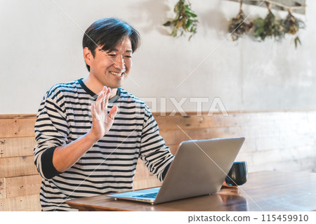 Businessman waving and greeting at web conference, remote conference, videophone 115459910