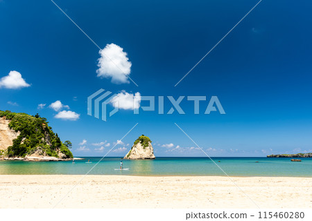People riding stand up paddleboards on a paradisiacal beach People riding stand up paddleboards on a paradisiacal beach 115460280