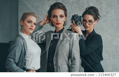 Professional model agency photoshoot, camera in hand, stylish business attire, creative industry professionals, modern studio setting, fashion photography session, elegant models posing 115460327