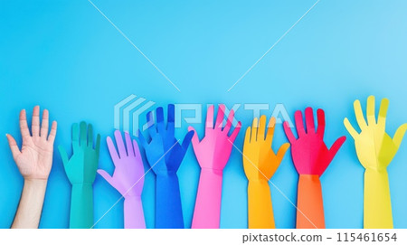 Colorful cut out paper hands of different skin colors reaching up on a blue background. 115461654