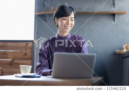 一位女士在咖啡館看電腦 115462528