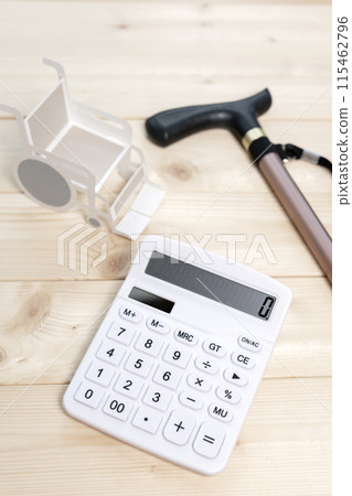 Wheelchair, cane and calculator, nursing care costs, medical costs Wheelchair, cane and calculator, nursing care costs, medical costs 115462796