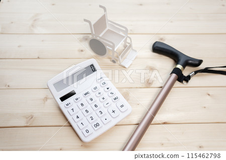 Wheelchair, cane and calculator, nursing care costs, medical costs Wheelchair, cane and calculator, nursing care costs, medical costs 115462798
