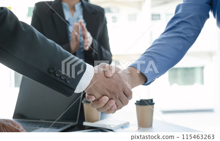 The businessmen shake hands after the meeting was successful and agreed upon 115463263