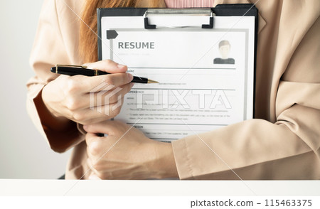 Business woman employer holding resume hiring recruit looking cv resume to hire candidates, analyzing information before job interview. Recruitment concepts Business woman employer holding resume hiring recruit looking cv resume to hire candidates, analyzing information before job interview. Recruitment concepts 115463375