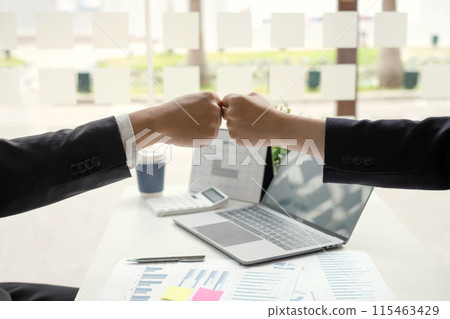 Two business leaders talk about charts, financial graphs showing results are analyzing and calculating planning strategies, business success building processes, and shake hands 115463429