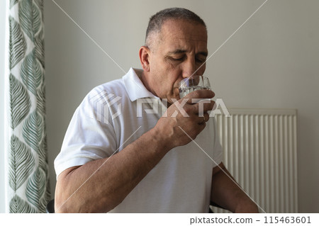 Portrait man with closed eyes drinking water from glass Portrait man with closed eyes drinking water from glass 115463601