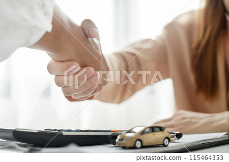 Businesswoman and brokers shake hands after completing negotiations to buy Car insurance and sign contracts. Car insurance concept 115464353