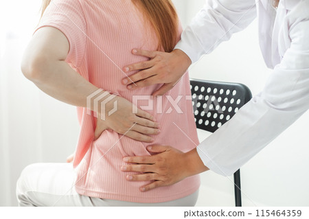Female physiotherapists provide physical assistance to women patients with back injuries back massages for relaxation and muscle recovery in the rehabilitation center 115464359