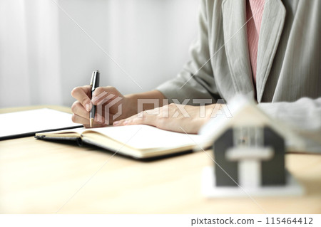 Agents working in real estate investment and home insurance signing contracts in accordance with the home buying insurance agreements approving purchases for clients.home insurance concept Agents working in real estate investment and home insurance signing contracts in accordance with the home buying insurance agreements approving purchases for clients.home insurance concept 115464412