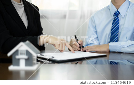 Real estate agents offer sale home insurance and close the sale immediately after the customer signs a purchase contract under a formal agreement. Real Estate Home insurance concept 115464619