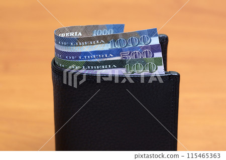 Liberian dollar in the black wallet 115465363