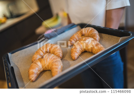 Close up picture of a tray with fresh croissants Close up picture of a tray with fresh croissants 115466098