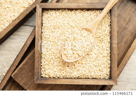 Brown rice in wooden box Brown rice in wooden box 115466171