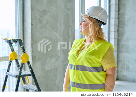 Technical profession woman in protective vest helmet working on construction Technical profession woman in protective vest helmet working on construction 115466214