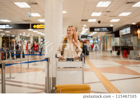 Woman Traveling Through Airport with Luggage, Smiling and Ready for Adventure, Modern Airport Terminal, Travel Concept, Female Traveler, Journey, Vacation, Business Trip, Departure, Arrival Woman Traveling Through Airport with Luggage, Smiling and Ready for Adventure, Modern Airport Terminal, Travel Concept, Female Traveler, Journey, Vacation, Business Trip, Departure, Arrival 115467105