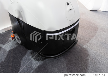Industrial robot vacuum cleaner at work. Industrial robot vacuum cleaner at work. 115467151