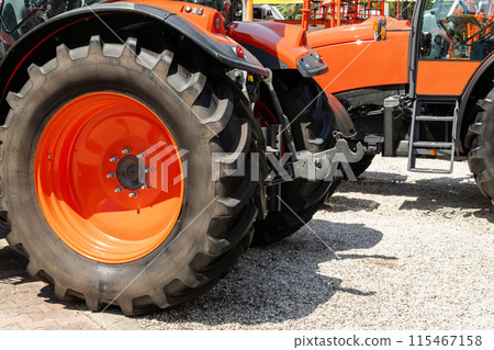 Row of red agricultural tractors for sale. Row of red agricultural tractors for sale. 115467158
