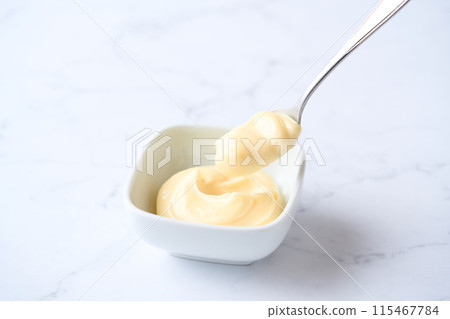 Mayonnaise served on a small plate 115467784