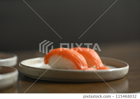 Nigiri sushi with salmon on ceramic plate. Japanese food style concept 115468032