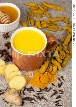 Natural Ayurvedic drink golden milk with turmeric and spices in a mug 115468484