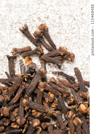 Dried clove spice on a gray stone background, macro 115468488