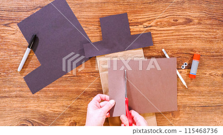 Step by step. Flat lay. Teacher guides online class through making a paper puppet from a brown bag, creatively using a wooden surface as a workspace. Step by step. Flat lay. Teacher guides online class through making a paper puppet from a brown bag, creatively using a wooden surface as a workspace. 115468736