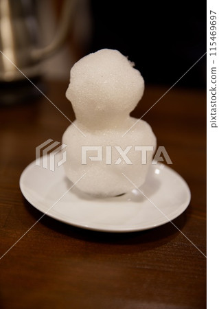 A white snowman on a white saucer A white snowman on a white saucer 115469697