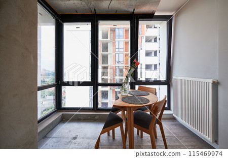 Photo collage of living room with large panoramic window before and after renovation. Old apartment with heating radiator and new renovated flat with flowers on table and elegant interior design. 115469974