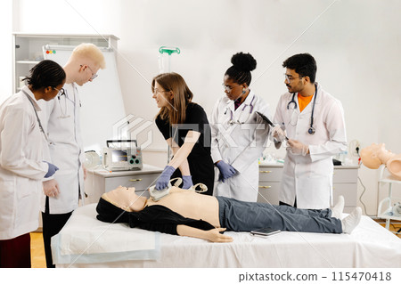 Medical Students Practicing CPR on a Mannequin in a Classroom Setting Medical Students Practicing CPR on a Mannequin in a Classroom Setting 115470418