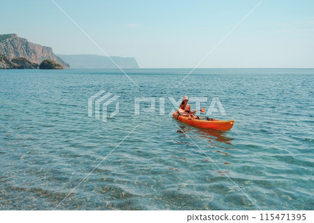 Kayak sea woman. Happy attractive woman with long hair in red swimsuit, swimming on kayak. Summer holiday vacation and travel concept. 115471395