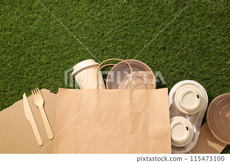 Ecological packaging for food delivery, on the grass. Ecological packaging for food delivery, on the grass. 115473100