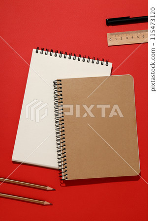 Two notebooks with stationery on a red background Two notebooks with stationery on a red background 115473120