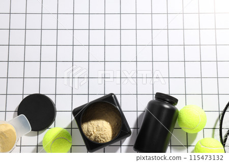 Black plastic jars, rackets and tennis balls on light background, space for text Black plastic jars, rackets and tennis balls on light background, space for text 115473132