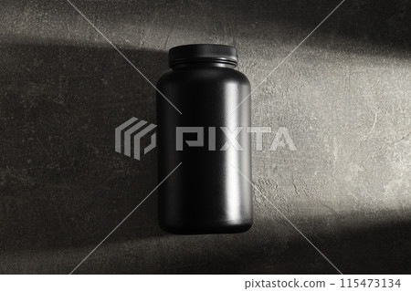Black plastic jar on dark gray background, top view Black plastic jar on dark gray background, top view 115473134