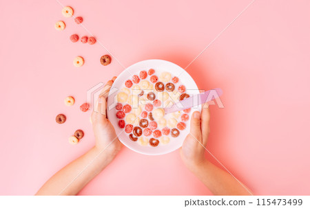 Breakfast of corn rings with milk on pink background 115473499