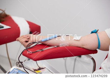 view of donor giving blood at donation center 115474209