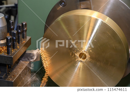 Closeup scene the lathe machine finish cut the brass parts by lathe tools. Closeup scene the lathe machine finish cut the brass parts by lathe tools. 115474611