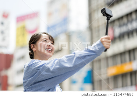 Young and pretty woman taking a selfie in the city's downtown | Osaka Tourism Image | Dotonbori, Osaka Prefecture | Ebisubashi Bridge 115474695