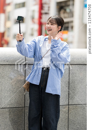 Young and pretty woman taking a selfie in the city's downtown | Osaka Tourism Image | Dotonbori, Osaka Prefecture | Ebisubashi Bridge 115474708