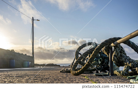 Ropes and ladder into the sea at coastal harbour Ropes and ladder into the sea at coastal harbour 115474722
