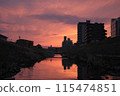 A river in a residential area dyed in the sunset 115474851