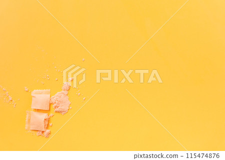 Contents of powder in snus bag on yellow background 115474876