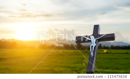 A red wooden cross on a blurred cemetery background. A red wooden cross on a blurred cemetery background. 115475638