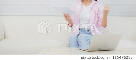 Young asian business woman working on laptop computer and looking graph and chart of report. Young asian business woman working on laptop computer and looking graph and chart of report. 115476292