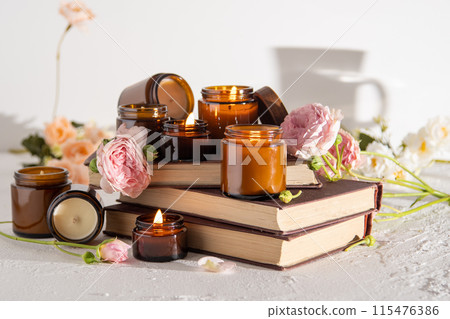 A set of different aroma candles in brown glass jars. Scented handmade candle. Soy candles are burning in a jar. Aromatherapy and relax in spa and home. Still life. Fire in brown jar 115476386
