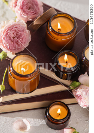 A set of different aroma candles in brown glass jars. Scented handmade candle. Soy candles are burning in a jar. Aromatherapy and relax in spa and home. Still life. Fire in brown jar 115476390