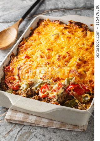 Delicious John Wayne casserole with beef, biscuits, cheese and vegetables close-up in a baking dish. Vertical Delicious John Wayne casserole with beef, biscuits, cheese and vegetables close-up in a baking dish. Vertical 115476586