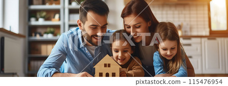 Parents and daughter playing with a wooden house model in the room. 115476954